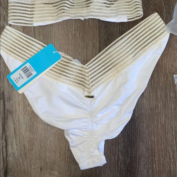 NWT Beach Bunny White and Gold Bikini 2 piece set
Halter top (L)
Bottoms (XL) - Picture 4 of 9